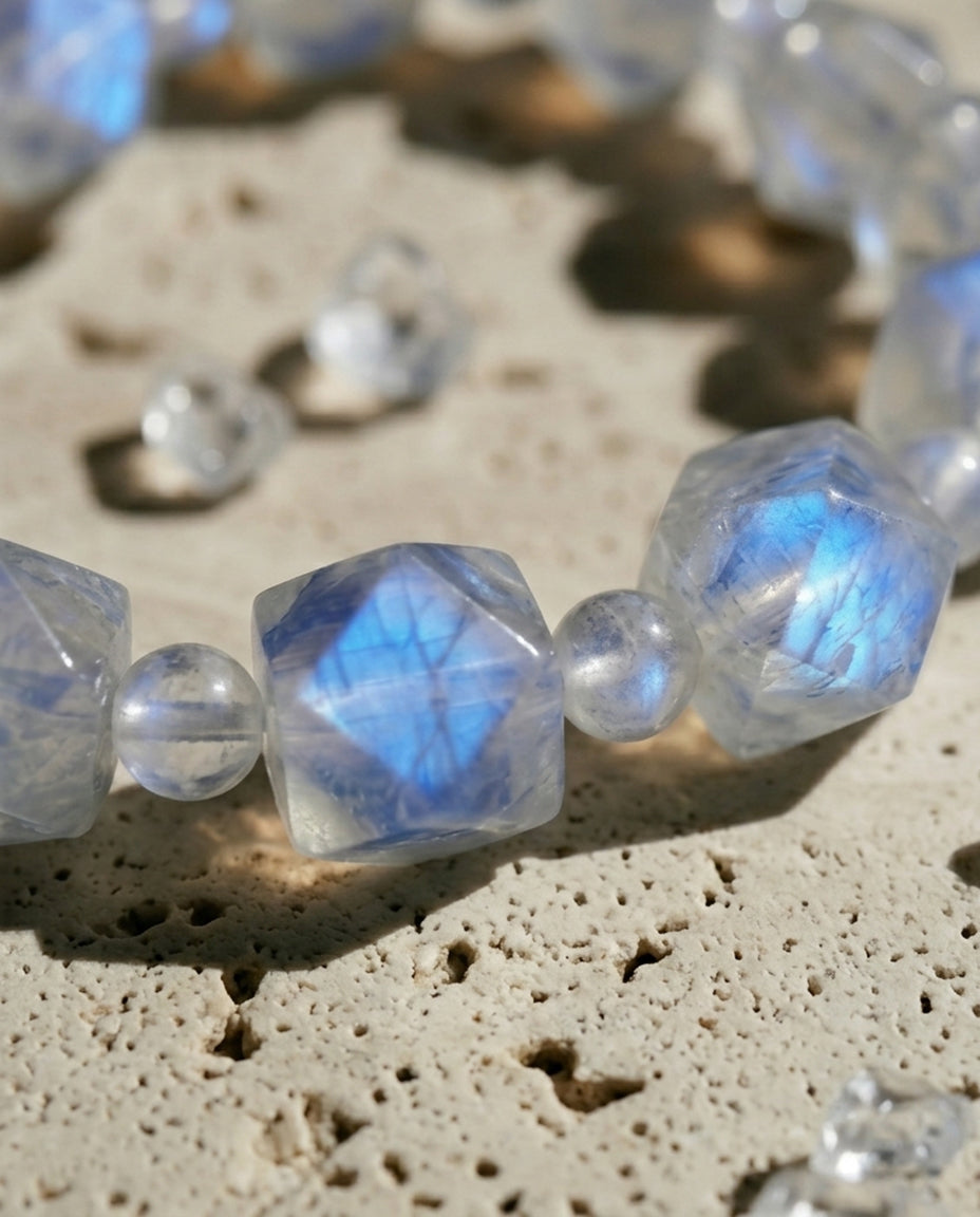 Close-up of premium faceted moonstone bracelet showing intense blue adularescence on rustic stone, mindful zero-metal accessory by STILLMANTLE