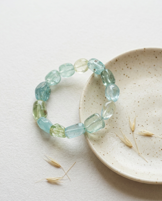 Close-up of zero-metal natural beryl crystal bracelet on a wabi-sabi ceramic dish, healing earth aesthetic accessory and mindful gift by STILLMANTLE