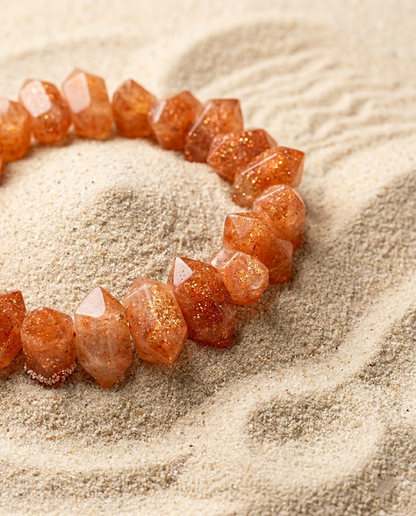⁠Angled view of large faceted sunstone crystal bracelet on minimalist sand ripples, earthy quiet luxury aesthetic accessory by STILLMANTLE⁠