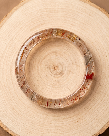 ⁠Close-up of premium Super Seven Melody Stone bangle showing vivid golden rutile and red lepidocrocite needles, zero-metal wearable art by STILLMANTLE