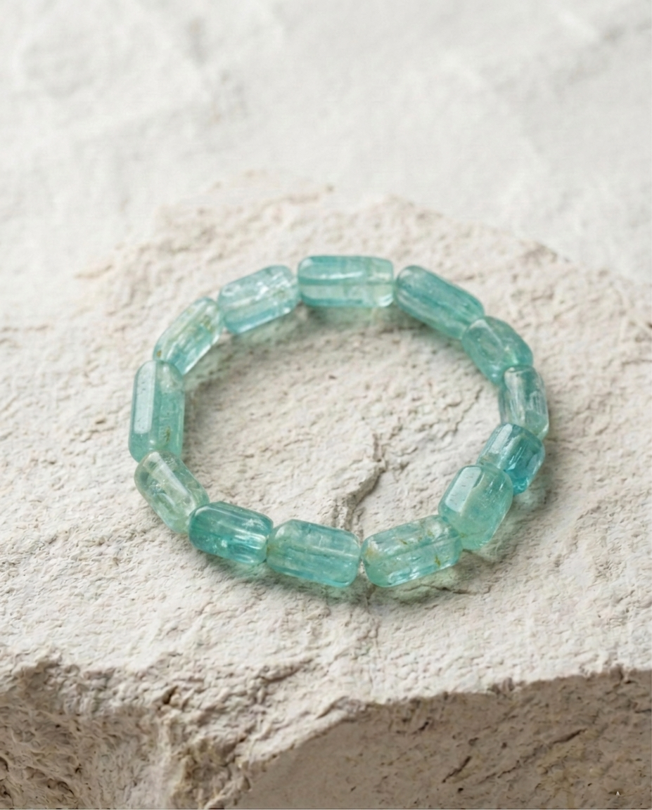 Zero-metal raw aquamarine crystal bracelet on textured white limestone, calming energy stone accessory for wabi-sabi lifestyle by STILLMANTLE