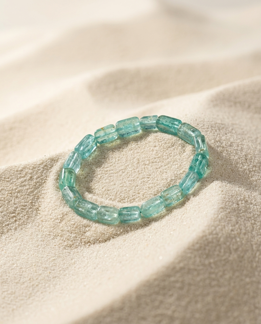 ⁠Natural blue aquamarine barrel bead bracelet resting on fine white sand, zen meditation aesthetic and minimalist zero-metal jewelry by STILLMANTLE⁠