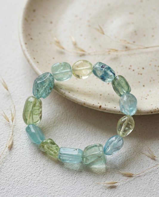 Mixed pastel beryl and aquamarine tumbled stone bracelet on a rustic ceramic plate with dried botanicals, quiet luxury mindful jewelry by STILLMANTLE⁠