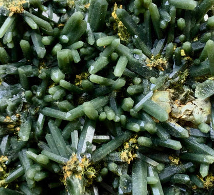 Macro detail of raw dark green prismatic quartz crystals with earthy yellow symbiotic minerals, unpolished geological specimen texture by STILLMANTLE⁠