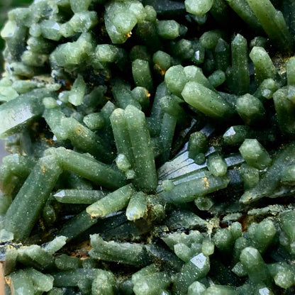 Close-up texture of interlocking forest green hedenbergite quartz crystal points, raw natural earth architecture by STILLMANTLE⁠