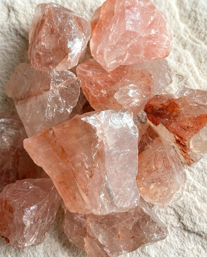 Close-up of raw hematoid quartz chunks showing deep crimson iron inclusions and icy facets, natural wabi-sabi essential oil diffuser stones by STILLMANTLE