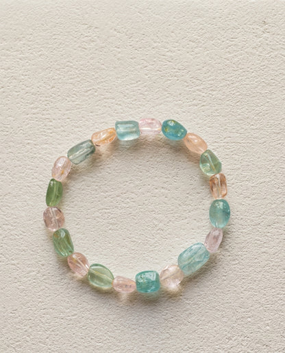 ⁠Macro close-up of a natural mixed beryl bracelet showing high transparency pink, blue, and green organic tumbled crystals, unheated luxury gemstone bracelet.⁠