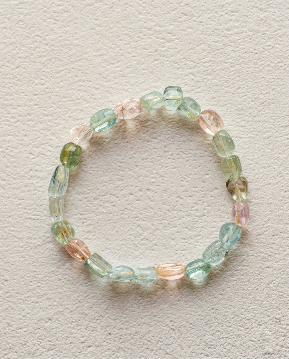 ⁠Macro close-up of a natural mixed beryl bracelet showing high transparency pink, blue, and green organic asymmetrical crystals, unheated luxury gemstone bracelet.⁠