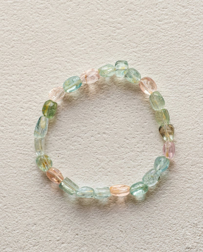 ⁠Macro close-up of a natural mixed beryl bracelet showing high transparency pink, blue, and green organic asymmetrical crystals, unheated luxury gemstone bracelet.⁠