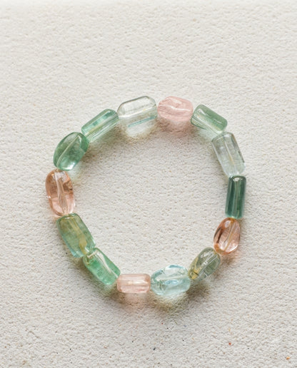 ⁠High-clarity mixed Beryl gemstone bracelet featuring natural Aquamarine and Morganite, styled on minimalist Zen garden sand ripples for wabi-sabi aesthetics.⁠