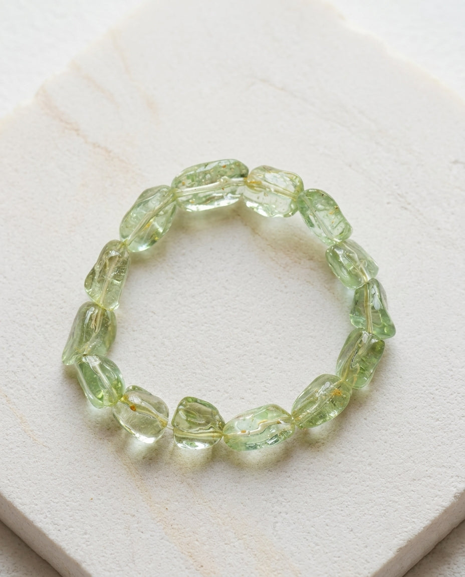 Natural Green Beryl gemstone bracelet styled with a handmade ceramic vase and dried branch for wabi-sabi aesthetic, minimalist fine mineral jewelry photography.