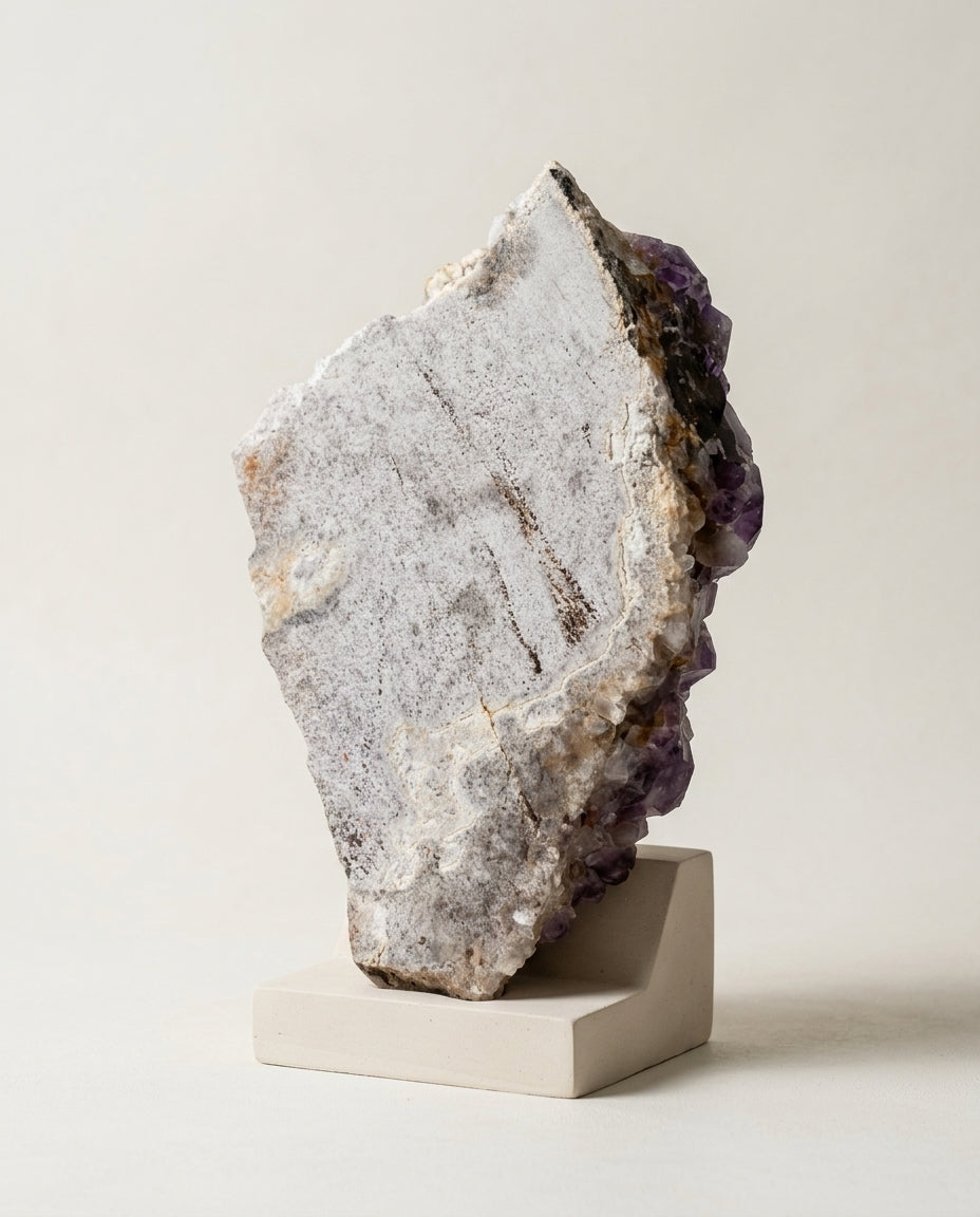 Top-down view of a massive raw Amethyst specimen, showcasing profoundly saturated purple crystal points and natural geological topography.