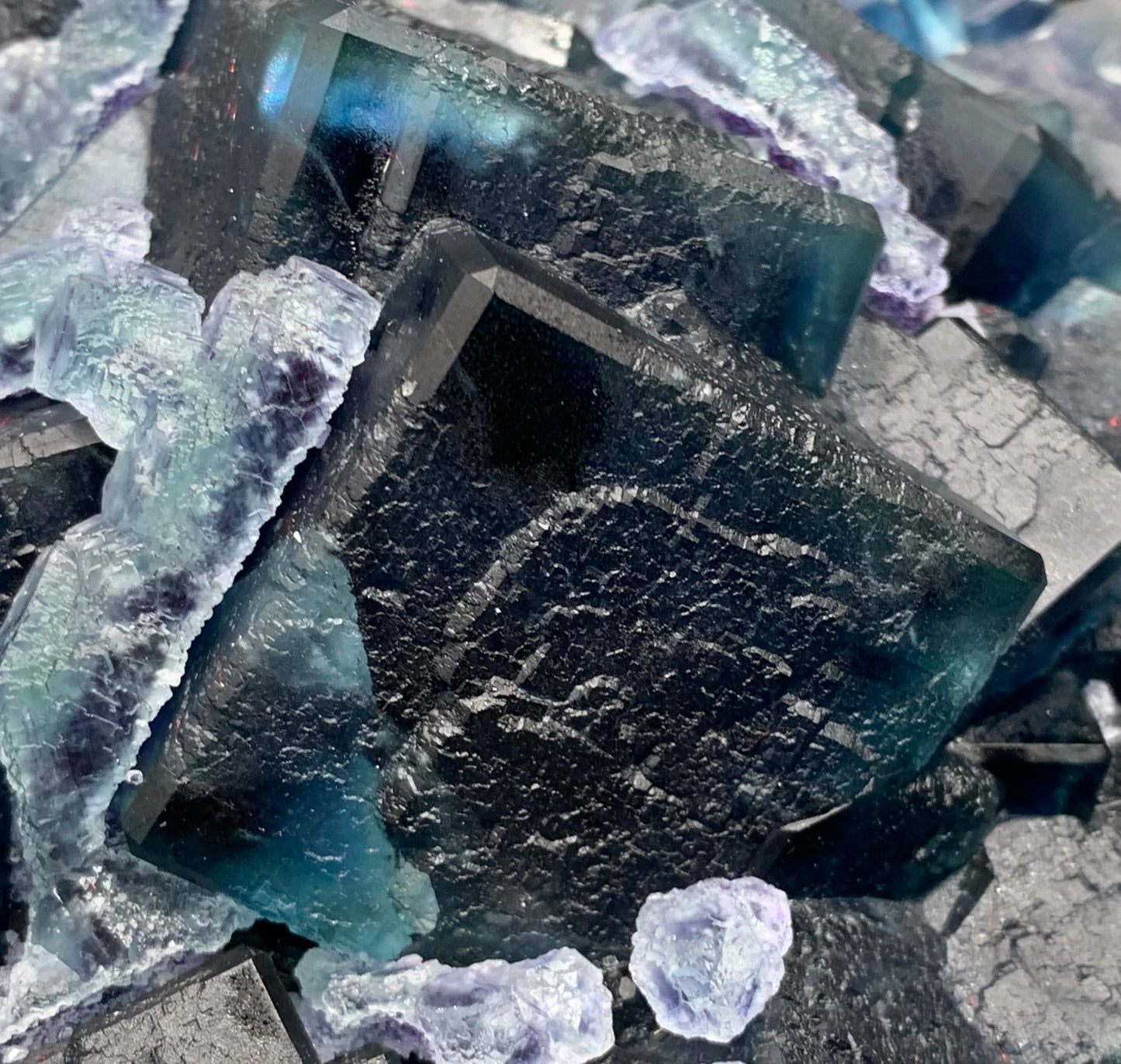 Macro close-up of natural dark blue cubic fluorite crystals with frosty secondary