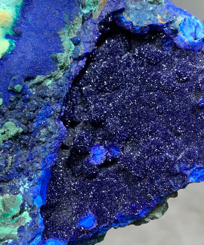 Extreme close up of sparkling raw azurite crystal cavity. Natural deep blue mineral stone detail for crystal collectors.⁠